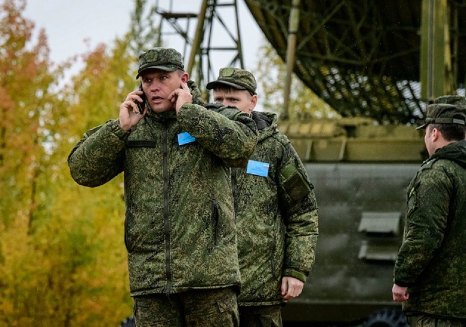 A Russian Army officer talks on the phone during the Vostok-2018  military drills at Telemba training ground PHOTO: AFP