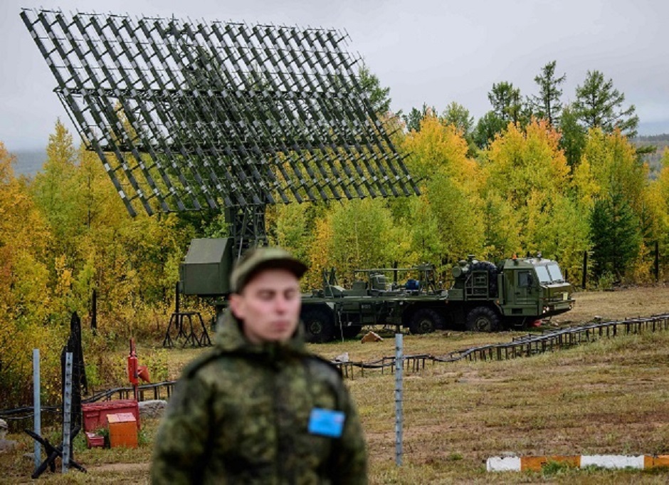 A Russian Army soldier stands guard in front of a radar installation during the Vostok-2018 (East-2018) military drills at Telemba training ground, some 130 km north of the Siberian city of Chita PHOTO: AFP