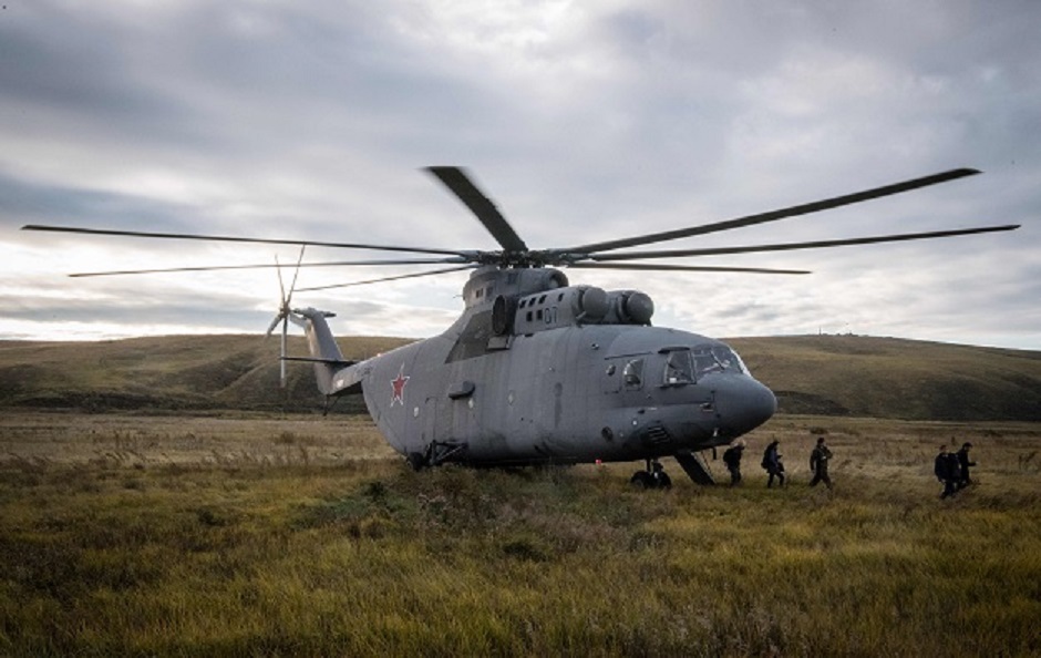 Foreign media journalists disembark from a Russian Army MI 26 helicopter as they arrive to report on the Vostok-2018 PHOTO: AFP