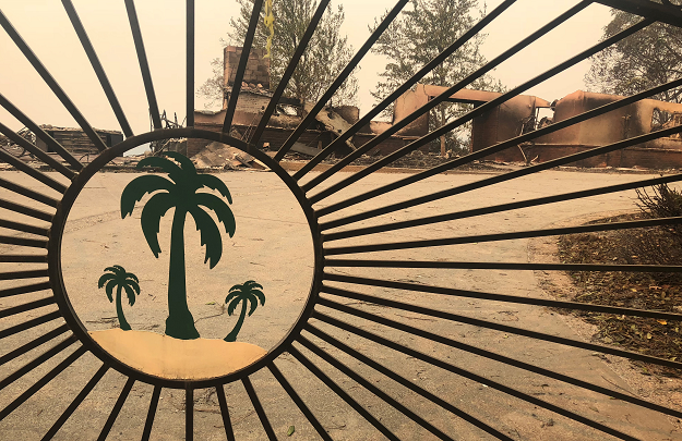 A home left in ruins is shown through an iron gate in the aftermath of wildfires which devastated the area in Paradise. PHOTO: REUTERS