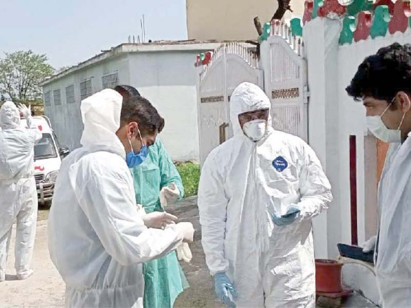 health officials don safety gear to check suspected covid 19 patients in bhara kahu photo zafar raja express