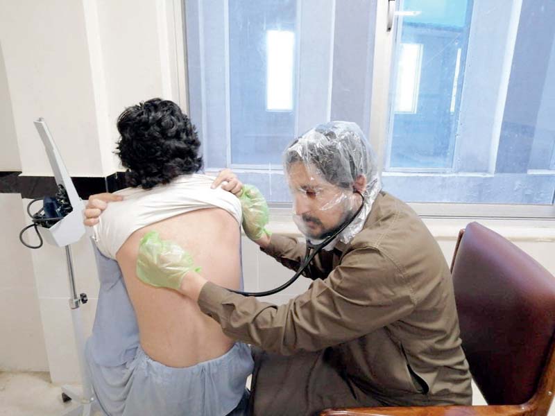 dr amir examines a suspected coronavirus patient at the yar hussain type d hospital photo express
