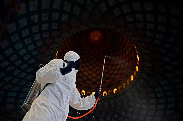 an officer of local disaster mitigation agency in protective suit sprays disinfectant at a mosque amid the spread of coronavirus in surabaya east java province indonesia photo reuters an officer of local disaster mitigation agency in protective suit sprays disinfectant at a mosque amid the spread of coronavirus in surabaya east java province indonesia photo reuters
