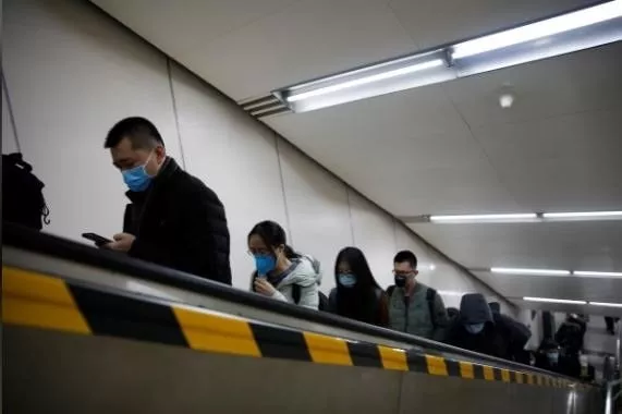 people wearing masks ride an escalator as they exit a subway station photo reuters people wearing masks ride an escalator as they exit a subway station photo reuters