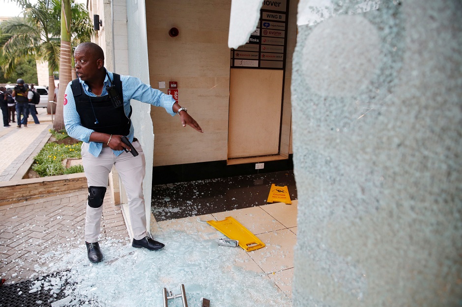 A policeman takes position at the scene where explosions and gunshots were heard at the Dusit hotel compound, in Nairobi, Kenya. PHOTO: REUTERS