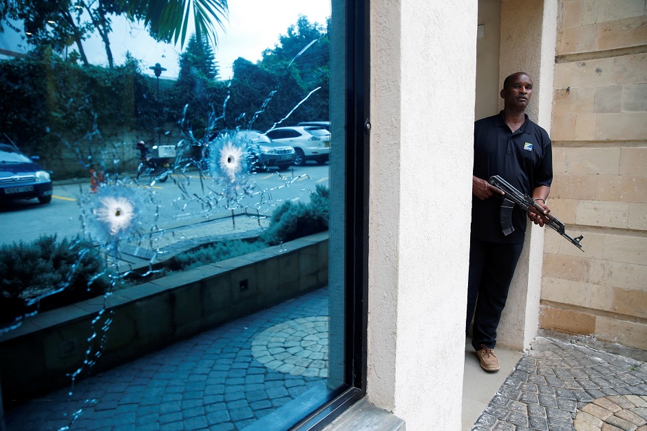 A policeman takes position at the scene where explosions and gunshots were heard at the Dusit hotel compound, in Nairobi, Kenya. PHOTO: REUTERS