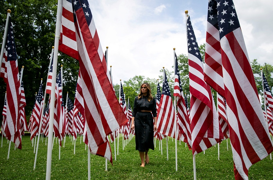 US first lady Melania Trump visits a field of American flags. REUTERS