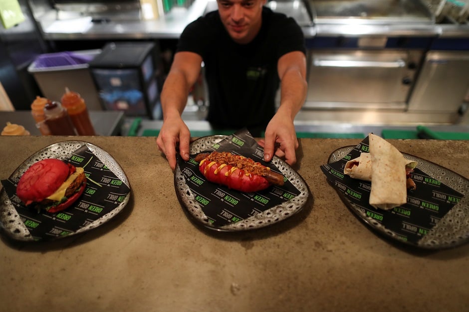 base, in Hong Kong, China A chef serves up vegan food in the Green Grill section of the Green Vic, which is aiming to be the world's most ethical pub, in Shoreditch, London, Britain:REUTERS