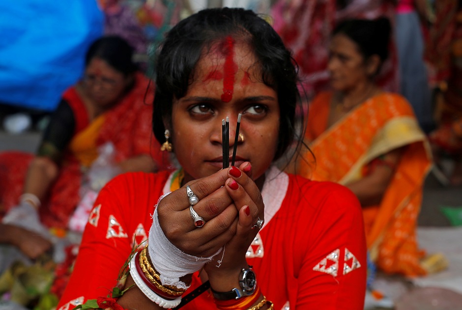 A woman worship Hindu goddess Bipadnashini during a religious ceremony in which married women fast for whole day for the betterment of their family in a temple premises in Kolkata, India:REUTERS