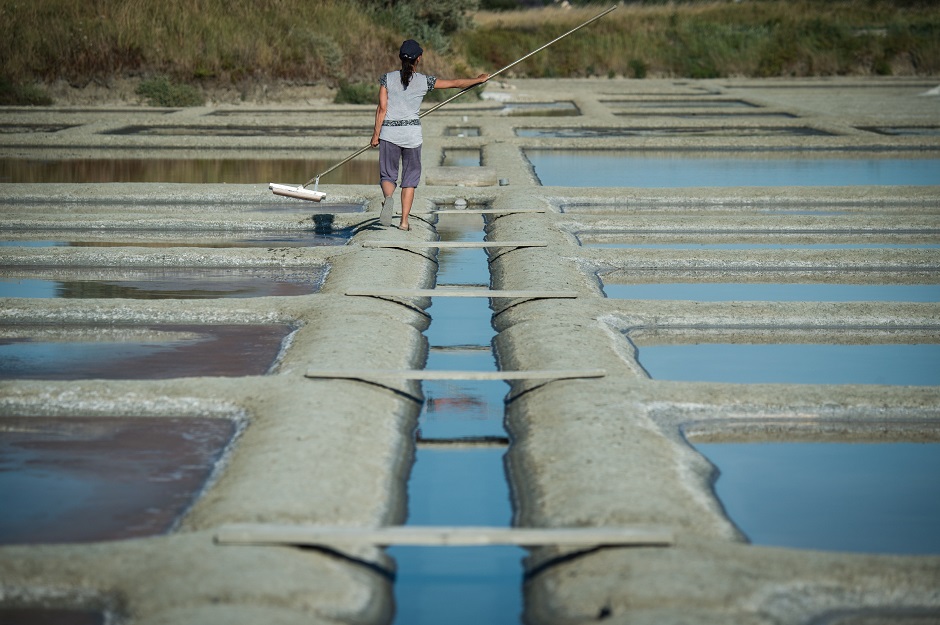 A salt worker harvests salt in Guerande, western France,:AFP