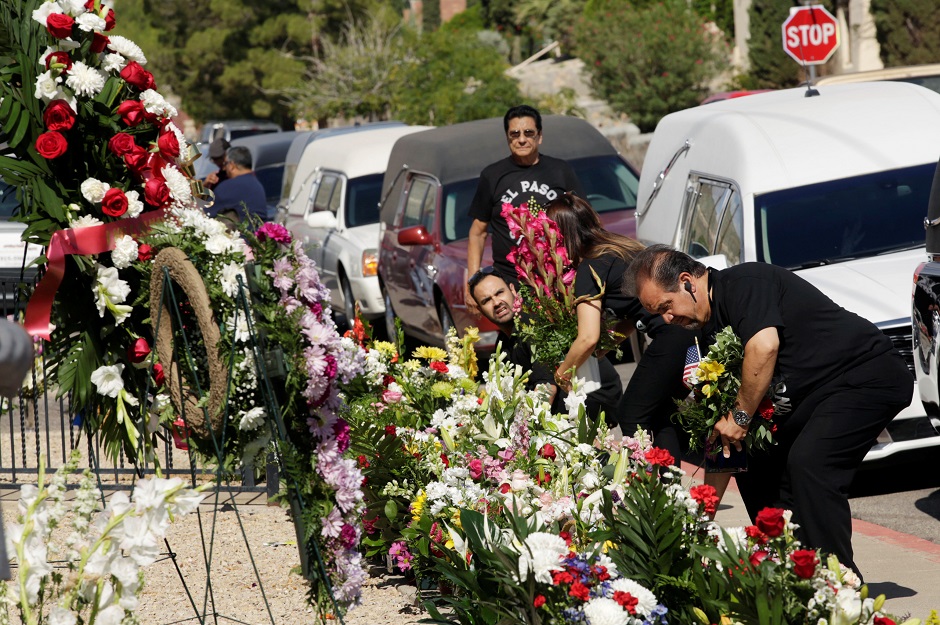 People put flowers during a tribute to the victims of a mass shooting at a Walmart store, in the growing memorial in El Paso, Texas, US. PHOTO: REUTERS 