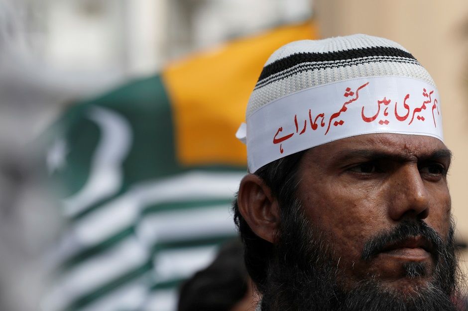 A man wears a headband that reads 