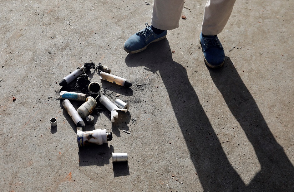 A Kashmiri boy stands next to empty teargas shells during clashes with Indian security forces. PHOTO: REUTERS
