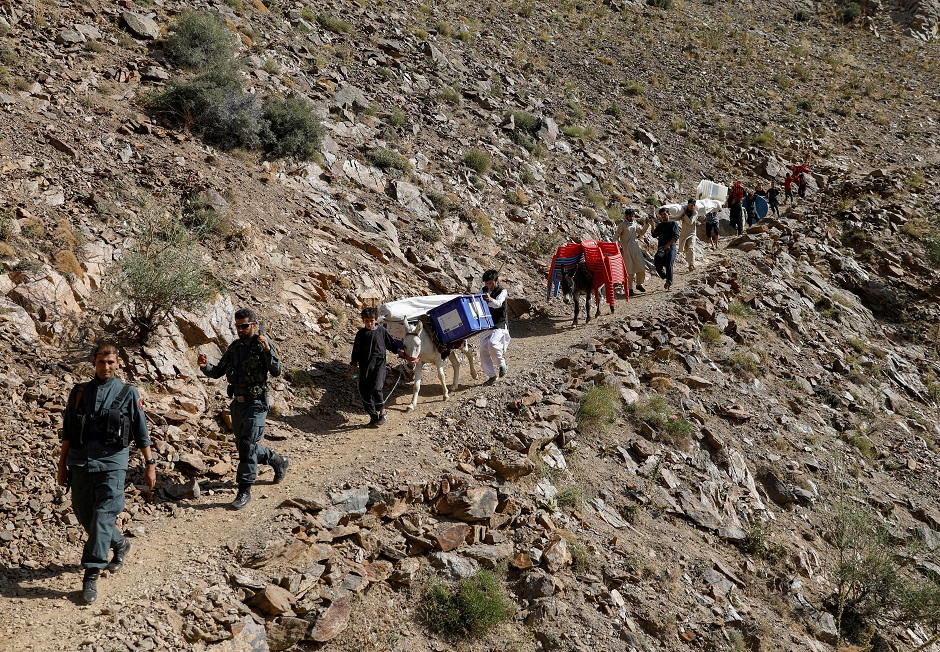 Afghan men lead donkeys loaded with ballot boxes and other election material to be transported to polling stations which are not accessible by road in Shutul, Panjshir province, Afghanistan. PHOTO: Reuters 