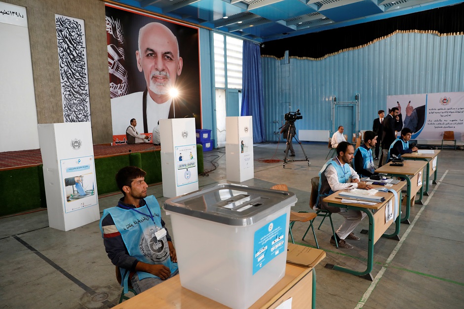 Election workers wait for Afghan presidential candidate Ashraf Ghani to vote in the presidential election in Kabul. PHOTO: Reuters 