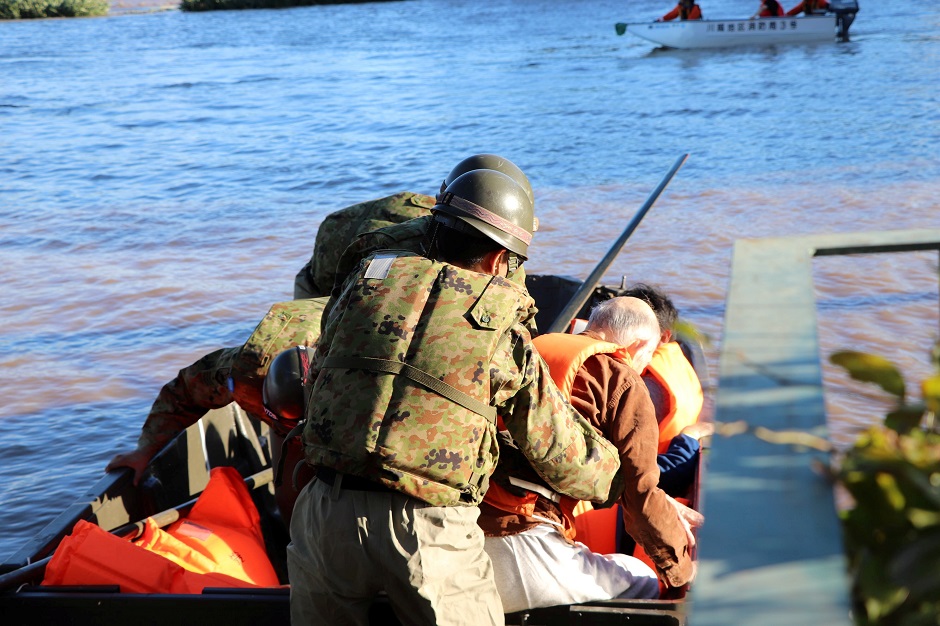 Rescue workers transport a resident in the aftermath of Typhoon Hagibis. PHOTO: REUTERS