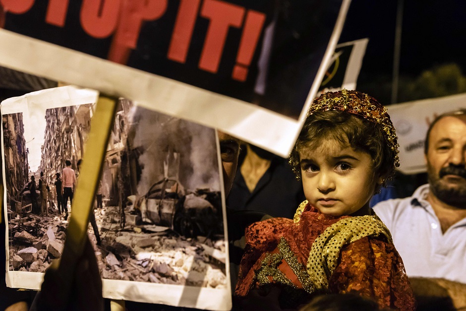 Demonstrators carry placards as they march in the Cypriot capital Nicosia on October 15, 2019 to protest against the Turkish offensive