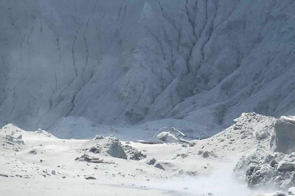 The picture shows wreckage of a helicopter amid ash minutes after the volcano on New Zealand's White Island erupted. PHOTO: AFP 