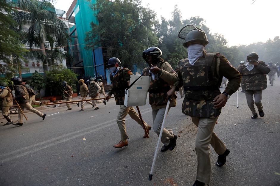  Police chase away demonstrators during a protest against a new citizenship law. PHOTO: REUTERS 