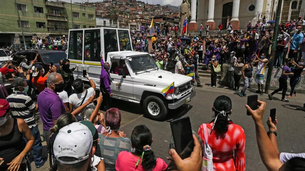 catholic faithful wearing face masks against the spread of the coronavirus watch the nazareno de san pablo motorcade procession to mark holy week celebrations in caracas on april 8 2020 photo afp