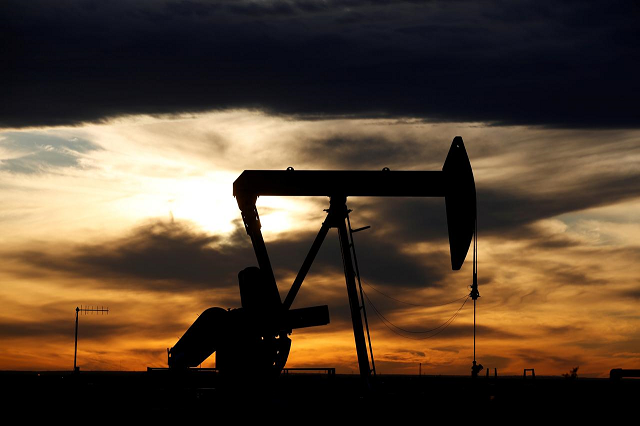 the sun sets behind a crude oil pump jack on a drill pad in the permian basin in loving county texas us november 24 2019 photo reuters