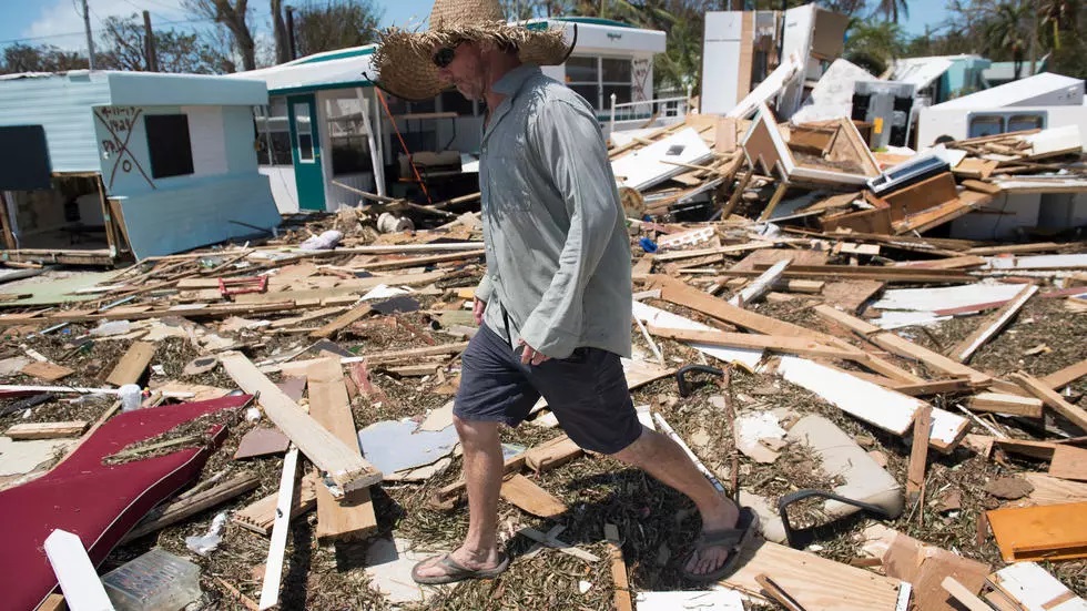 in this file photo taken on september 12 2017 bill quinn surveys the damage caused to his trailer home from hurricane irma at the seabreeze trailer park in islamorada in the florida keys photo afp