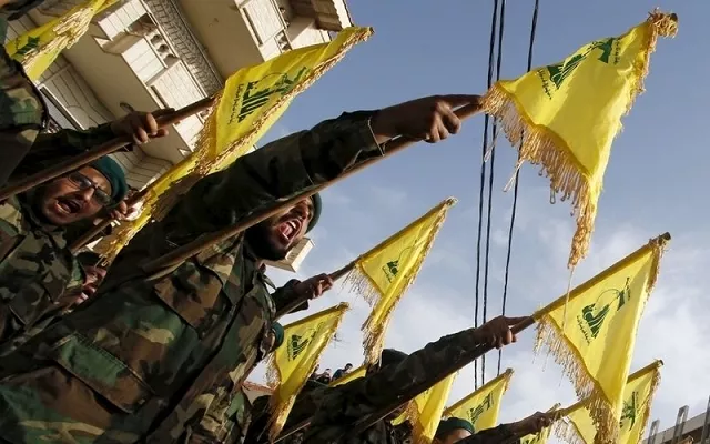 members carry hezbollah flags during the funeral of a fellow fighter in southern lebanon photo reuters members carry hezbollah flags during the funeral of a fellow fighter in southern lebanon photo reuters