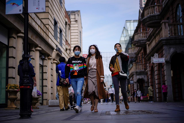 people wearing face masks are seen at a main shopping area after the lockdown was lifted in wuhan capital of hubei province and china 039 s epicentre of the novel coronavirus disease covid 19 outbreak april 14 2020 photo reuters