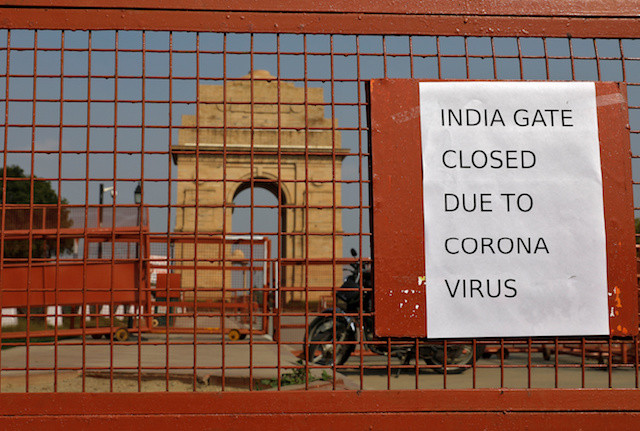a sign pasted on a security barricade is seen after the india gate war memorial was closed for visitors amid measures for coronavirus prevention in new delhi india on thursday photo reuters
