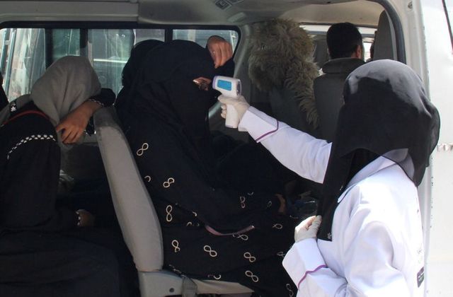 a health worker takes temperature of passengers of a van amid fear of coronavirus disease covid 19 on the outskirts of taiz yemen april 12 2020 photo reuters