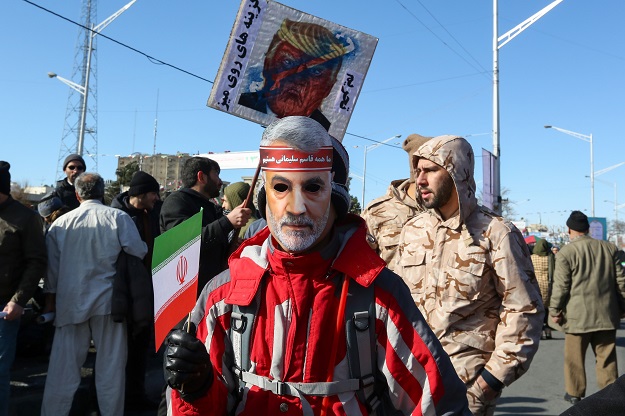 Iranians carry a mock coffin bearing the colors of the US flag during commemorations marking 41 years since the Islamic Revolution in the capital Tehran's Azadi Square on February 11. PHOTO: AFP