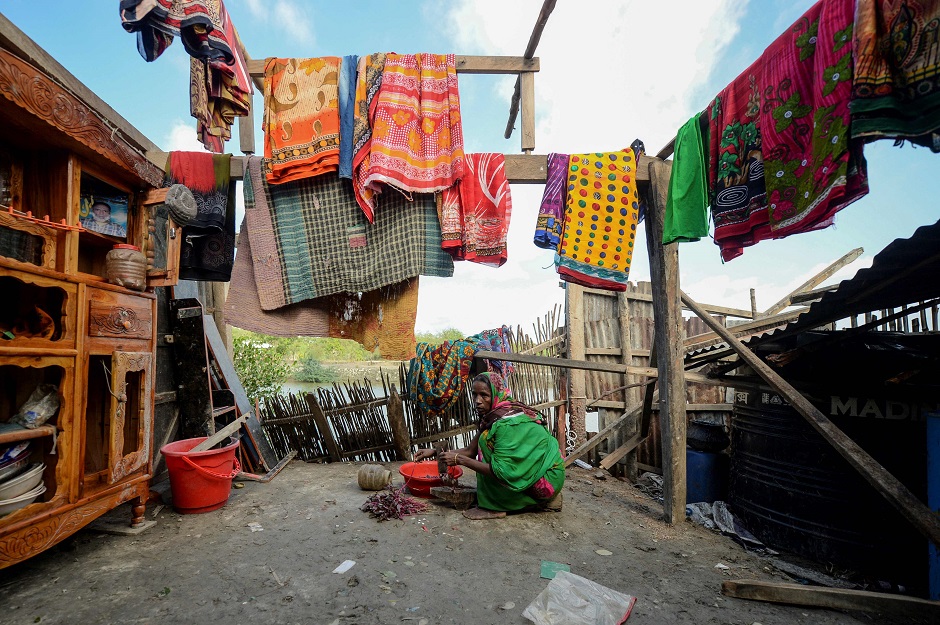 Bangladeshi mother-of-four Mosammat Rashida, whose husband was killed by a Bengal tiger a decade ago while he was collecting honey, prepares a meal at her house in Shyamnagar. PHOTO: AFP
