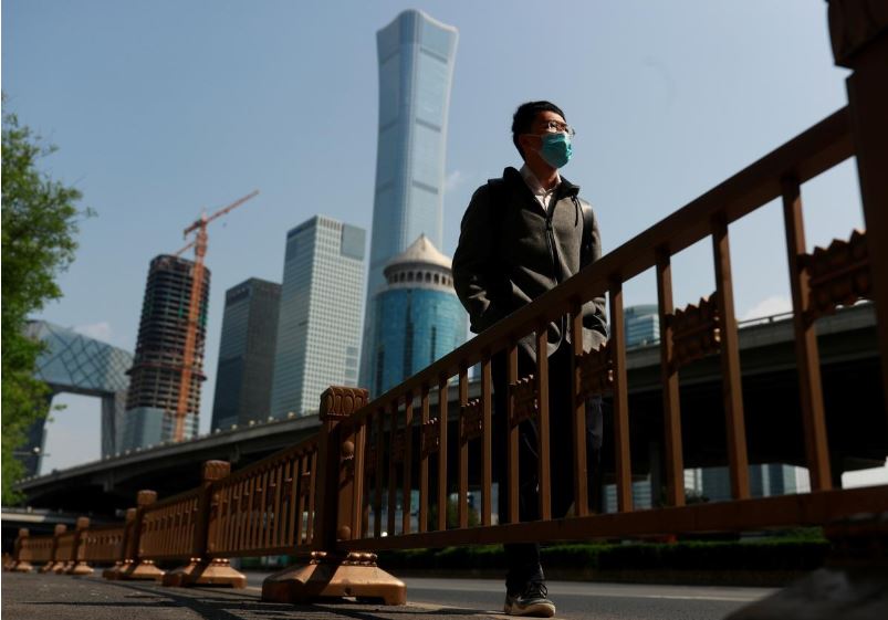 a walks by beijing 039 s central business district during morning rush hour as the spread of the new coronavirus disease covid 19 continues in china photo reuters