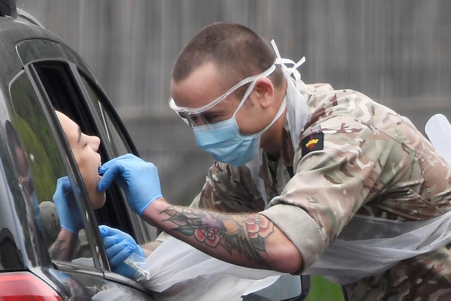a member of the military tests a person at a coronavirus test centre in the car park of chessington world of adventures as the spread of the coronavirus disease covid 19 continues chessington britain london britain april 18 2020 photo reuters