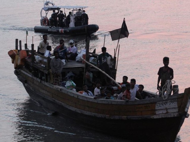 rohingya refugees who were intercepted by malaysian maritime enforcement agency off langkawi island are escorted in their boat as they are handed over to immigration authorities at the kuala kedah ferry jetty in malaysia photo reuters