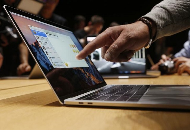 a guest points to a new macbook pro during an apple media event in cupertino california us october 27 2016 photo reuters