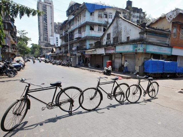 a man rides past a line of cycles erected across a road as a blockade during a nationwide lockdown to slow the spread of the coronavirus disease covid 19 in mumbai india photo reuters file