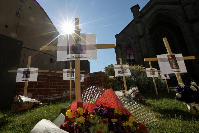 pictures and names of people who died during the lockdown hang on crosses in a remembrance garden near a church during the coronavirus disease covid 19 outbreak in burton in staffordshire britain april 24 2020 photo reuters