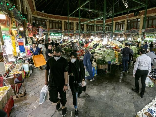 shoppers clad in protective gear including face masks and latex gloves walk through tajrish bazaar in iran 039 s capital tehran at the start of the muslim holy month of ramazan photo afp