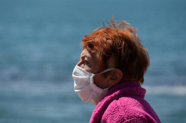 a woman wears a face mask at the touristic port in ostia near rome as the spread of the coronavirus disease covid 19 continues in italy april 26 2020 photo reuters