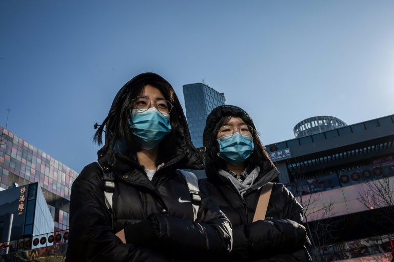 chinese girls wear protective masks in beijing on january 23 2020 photo afp