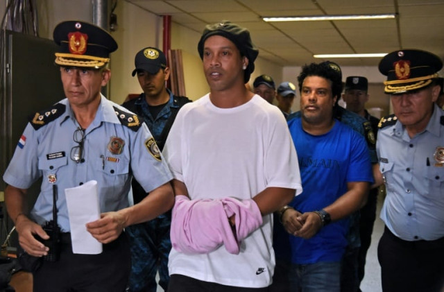 ronaldinho and his brother roberto de assis moreira are accused of entering paraguay in possession of false passports photo afp ronaldinho and his brother roberto de assis moreira are accused of entering paraguay in possession of false passports photo afp