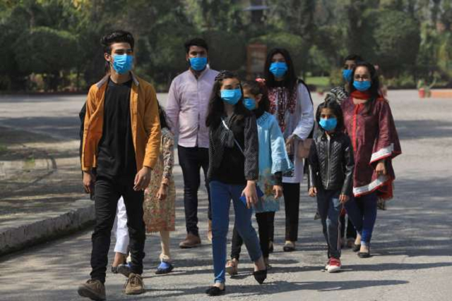 volunteers wear masks as a preventive measure against the coronavirus as they walk during an awareness compaign by a ngo at the premises of the st john cathedral in peshawar photo reuters