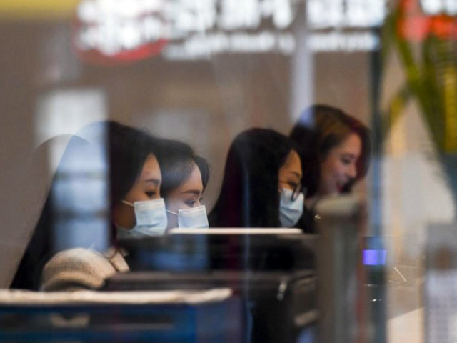 tellers wearing face masks work at a currency exchange store in melbourne photo afp file