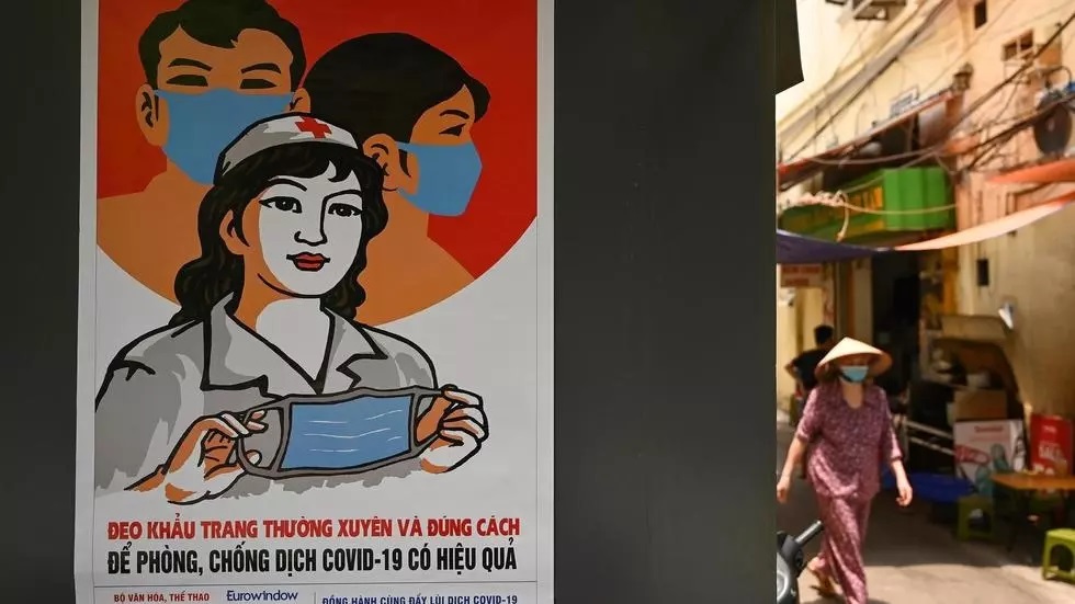 a poster in the style of vietnamese communist propaganda art warns against the spread of coronavirus in hanoi photo afp