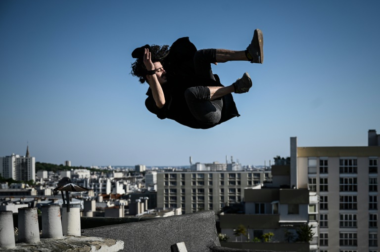 nogueira climbs above his beloved paris day and night to practice his sport across the roofs and sills photo afp