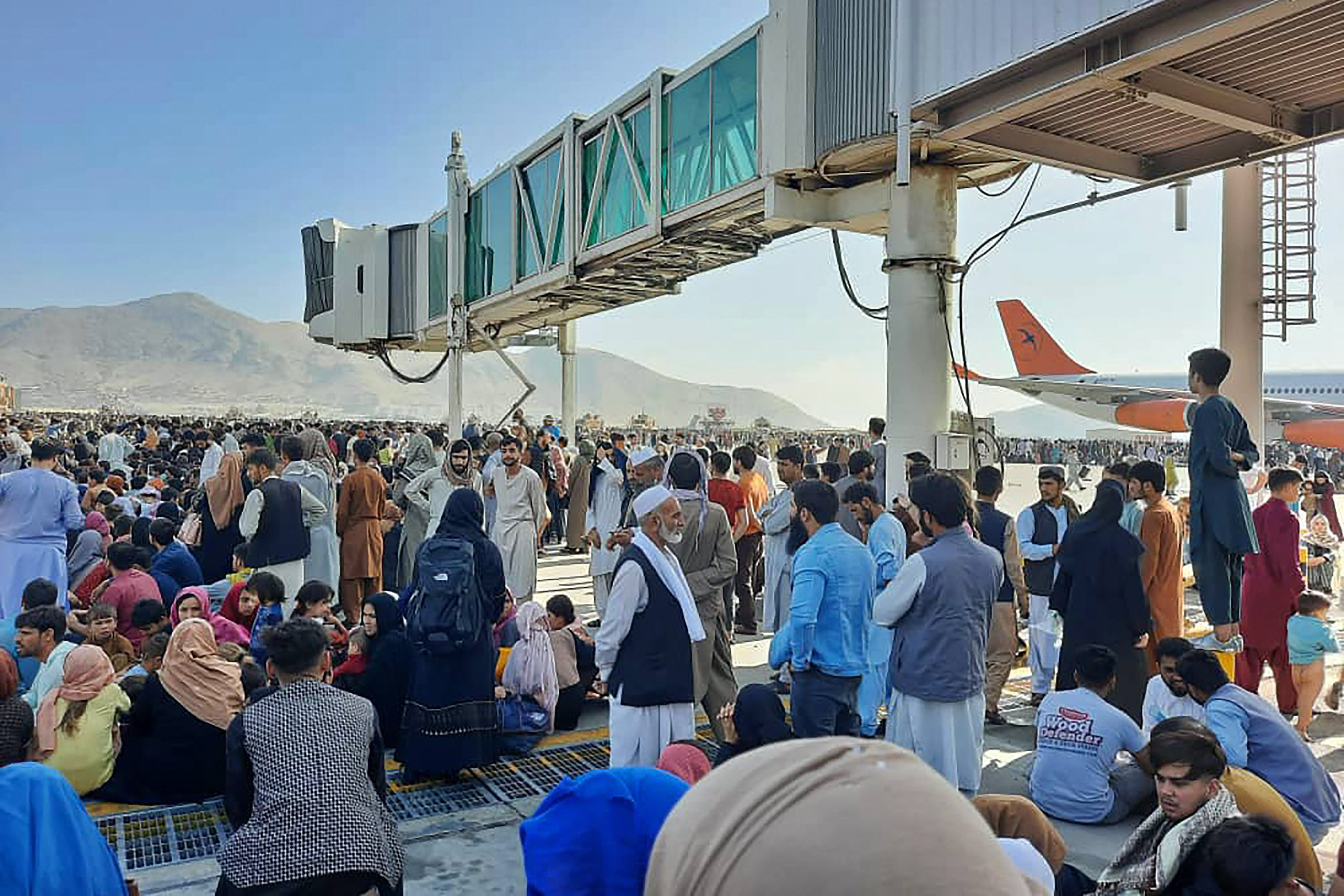 afghans crowd at the tarmac of the kabul airport to flee the country as the taliban took control of afghanistan after president ashraf ghani fled the country and conceded the insurgents had won the 20 year war photo afp