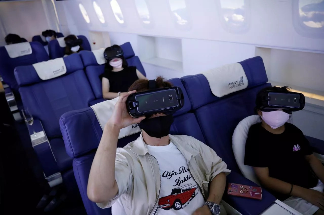 customers in flight seats use virtual reality vr devices at first airlines that provides vr flight experiences including 360 degree tours of cities and meals amid the covid 19 pandemic in tokyo japan august 12 2020 photo reuters customers in flight seats use virtual reality vr devices at first airlines that provides vr flight experiences including 360 degree tours of cities and meals amid the covid 19 pandemic in tokyo japan august 12 2020 photo reuters