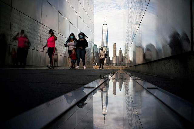 people visit the empty sky memorial as the the one world trade center in new york is seen from liberty state park after many new jersey parks set to re open during the outbreak of the coronavirus disease covid 19 in jersey city new jersey us may 2 2020 reuters