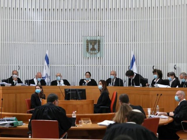 a panel of judges of the israeli supreme court wear face masks as they address a discussion on a petition asking whether israeli prime minister benjamin netanyahu can form a government legally and publicly when indictments are filed against him on a charges of fraud bribery and breach of trust at the israeli supreme court in jerusalem photo reuters